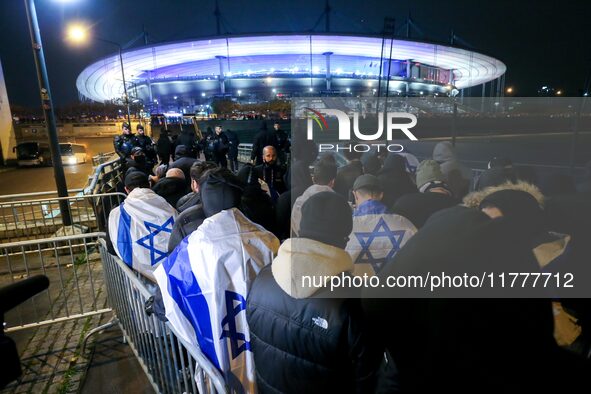 Supporters with Israeli flags queue outside the Stade de France stadium ahead of the UEFA Nations League League A, Group A2 football match b...