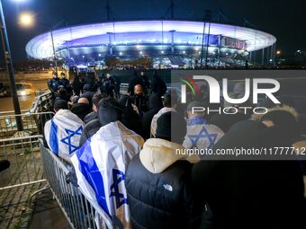 Supporters with Israeli flags queue outside the Stade de France stadium ahead of the UEFA Nations League League A, Group A2 football match b...