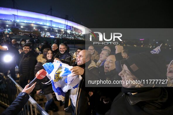 Supporters with Israeli flags queue outside the Stade de France stadium ahead of the UEFA Nations League League A, Group A2 football match b...