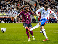 Italy forward Mateo Retegui and Belgium defender Zeno Debast play during the match between Belgium and Italy at the King Baudouin Stadium fo...