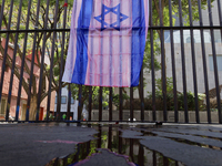 A pro-Palestine activist paints an Israeli flag in Mexico City, Mexico, outside the Museo Memoria y Tolerancia, where people demand that Cla...