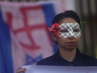 Pro-Palestine activists in Mexico City, Mexico, on November 14, 2024, demonstrate outside the Memory and Tolerance Museum, where they demand...