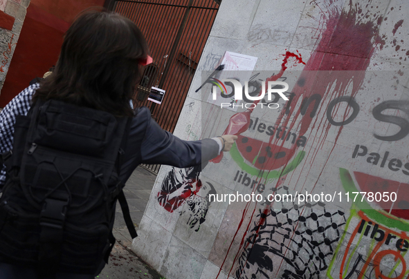 Pro-Palestine activists in Mexico City, Mexico, on November 14, 2024, paint graffiti outside the Memory and Tolerance Museum, where they dem...