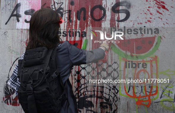 Pro-Palestine activists in Mexico City, Mexico, on November 14, 2024, paint graffiti outside the Memory and Tolerance Museum, where they dem...