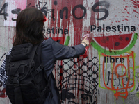 Pro-Palestine activists in Mexico City, Mexico, on November 14, 2024, paint graffiti outside the Memory and Tolerance Museum, where they dem...