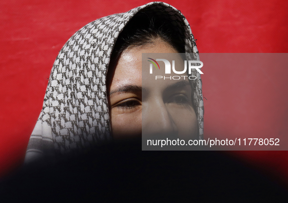 A pro-Palestine activist stands in Mexico City, Mexico, outside the Ministry of Foreign Affairs, where more people demand that Claudia Shein...