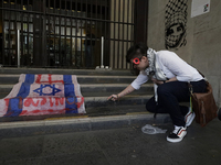 A pro-Palestine activist in Mexico City, Mexico, burns an Israeli flag outside the Ministry of Foreign Affairs, where more people demand tha...