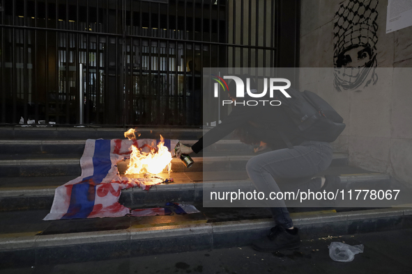 Pro-Palestinian activists in Mexico City, Mexico, on November 14, 2024, burn an Israeli flag outside the Ministry of Foreign Affairs, where...