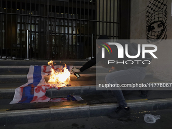 Pro-Palestinian activists in Mexico City, Mexico, on November 14, 2024, burn an Israeli flag outside the Ministry of Foreign Affairs, where...