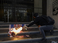 Pro-Palestinian activists in Mexico City, Mexico, on November 14, 2024, burn an Israeli flag outside the Ministry of Foreign Affairs, where...