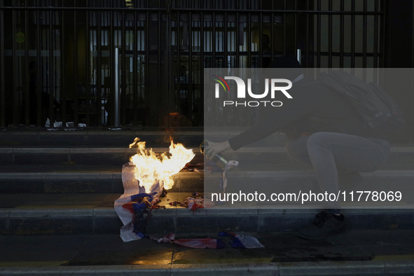 Pro-Palestinian activists in Mexico City, Mexico, on November 14, 2024, burn an Israeli flag outside the Ministry of Foreign Affairs, where...