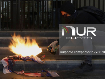 Pro-Palestinian activists in Mexico City, Mexico, on November 14, 2024, burn an Israeli flag outside the Ministry of Foreign Affairs, where...