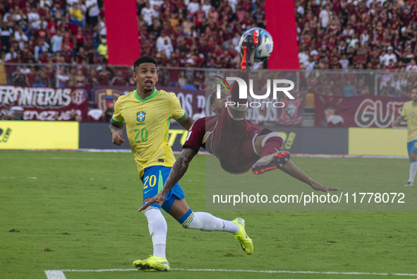 Jose Andres Martinez of Venezuela competes for the ball with Savinho of Brazil during a 2026 FIFA World Cup qualifier at the Monumental stad...