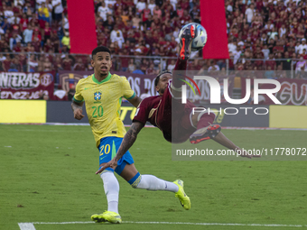 Jose Andres Martinez of Venezuela competes for the ball with Savinho of Brazil during a 2026 FIFA World Cup qualifier at the Monumental stad...