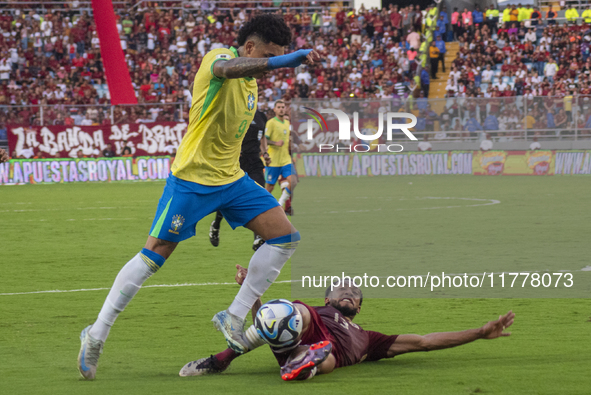 Jose Andres Martinez of Venezuela competes for the ball with Igor Jesus of Brazil during a 2026 FIFA World Cup qualifier at the Monumental s...