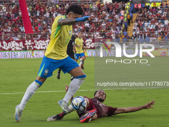 Jose Andres Martinez of Venezuela competes for the ball with Igor Jesus of Brazil during a 2026 FIFA World Cup qualifier at the Monumental s...