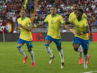 Brazilian national team players celebrate after scoring a goal during the 2026 FIFA World Cup qualifier against Venezuela at the Monumental...