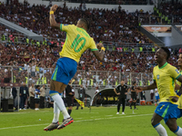 Brazilian national team players celebrate after scoring a goal during the 2026 FIFA World Cup qualifier against Venezuela at the Monumental...