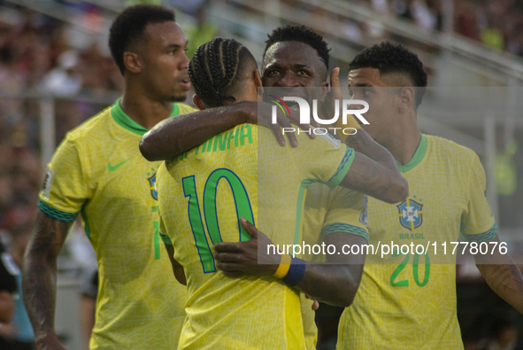 Brazilian national team players celebrate after scoring a goal during the 2026 FIFA World Cup qualifier against Venezuela at the Monumental...