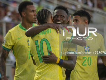 Brazilian national team players celebrate after scoring a goal during the 2026 FIFA World Cup qualifier against Venezuela at the Monumental...