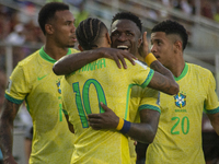 Brazilian national team players celebrate after scoring a goal during the 2026 FIFA World Cup qualifier against Venezuela at the Monumental...