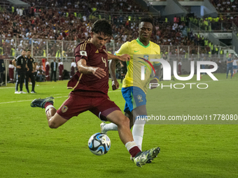 Jon Aramburu of Venezuela fights for the ball with a player from Brazil during a 2026 FIFA World Cup qualifier at the Monumental stadium in...