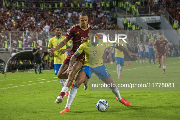 Eric Ramirez of Venezuela competes for the ball with a player from Brazil during a 2026 FIFA World Cup qualifier at the Monumental stadium i...