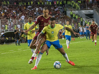 Eric Ramirez of Venezuela competes for the ball with a player from Brazil during a 2026 FIFA World Cup qualifier at the Monumental stadium i...