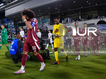 Qatar and Uzbekistan players walk onto the pitch before the FIFA World Cup 2026 AFC Asian Qualifiers 3rd round group A match between Qatar a...