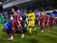 Qatar and Uzbekistan players walk onto the pitch before the FIFA World Cup 2026 AFC Asian Qualifiers 3rd round group A match between Qatar a...