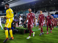 Qatar and Uzbekistan players walk onto the pitch before the FIFA World Cup 2026 AFC Asian Qualifiers 3rd round group A match between Qatar a...