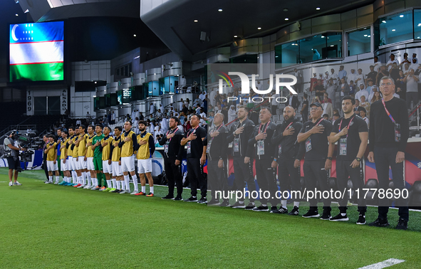 Uzbekistan National team head coach Srecko Katanec, his staff, and substitutes line up for the national anthem before the FIFA World Cup 202...