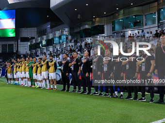 Uzbekistan National team head coach Srecko Katanec, his staff, and substitutes line up for the national anthem before the FIFA World Cup 202...