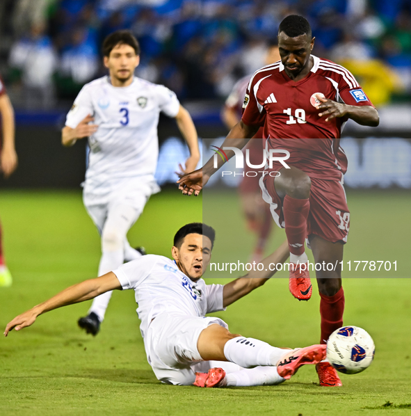 Almoez Ali (#19) of Qatar battles for the ball with Khusniddin Alikulov (#23) of Uzbekistan during the FIFA World Cup 2026 AFC Asian Qualifi...