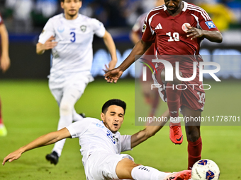 Almoez Ali (#19) of Qatar battles for the ball with Khusniddin Alikulov (#23) of Uzbekistan during the FIFA World Cup 2026 AFC Asian Qualifi...