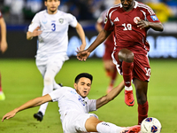 Almoez Ali (#19) of Qatar battles for the ball with Khusniddin Alikulov (#23) of Uzbekistan during the FIFA World Cup 2026 AFC Asian Qualifi...