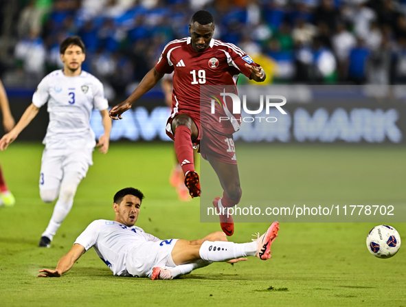 Almoez Ali (#19) of Qatar battles for the ball with Khusniddin Alikulov (#23) of Uzbekistan during the FIFA World Cup 2026 AFC Asian Qualifi...