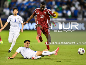 Almoez Ali (#19) of Qatar battles for the ball with Khusniddin Alikulov (#23) of Uzbekistan during the FIFA World Cup 2026 AFC Asian Qualifi...