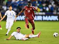 Almoez Ali (#19) of Qatar battles for the ball with Khusniddin Alikulov (#23) of Uzbekistan during the FIFA World Cup 2026 AFC Asian Qualifi...