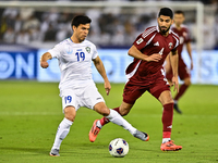 Mohammed Waad (#4) of Qatar competes for the ball with Azizbek Turgunboev (#19) of Uzbekistan during the FIFA World Cup 2026 AFC Asian Quali...