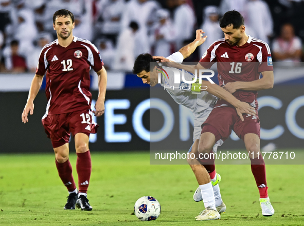 Boualem Khoukhi (#16) of Qatar competes for the ball with Eldor Shomurodov (#14) of Uzbekistan during the FIFA World Cup 2026 AFC Asian Qual...