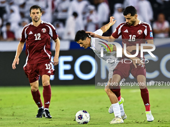 Boualem Khoukhi (#16) of Qatar competes for the ball with Eldor Shomurodov (#14) of Uzbekistan during the FIFA World Cup 2026 AFC Asian Qual...