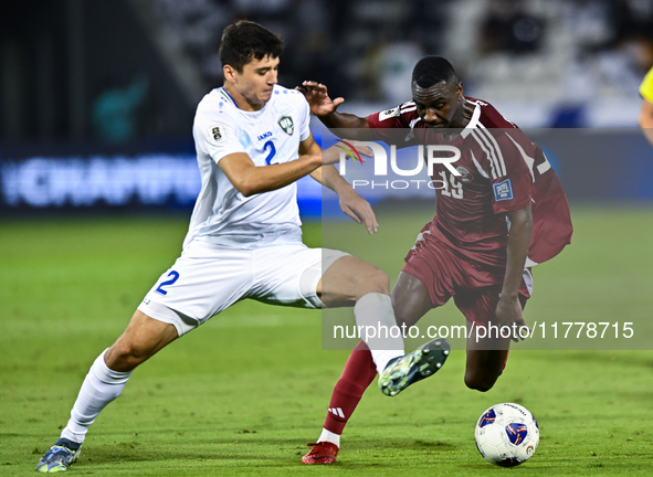 Almoez Ali (#19) of Qatar battles for the ball with Abdukodir Khusanov (#2) of Uzbekistan during the FIFA World Cup 2026 AFC Asian Qualifier...