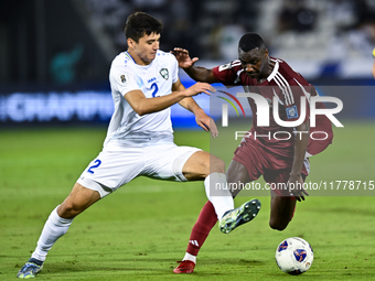 Almoez Ali (#19) of Qatar battles for the ball with Abdukodir Khusanov (#2) of Uzbekistan during the FIFA World Cup 2026 AFC Asian Qualifier...