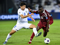 Almoez Ali (#19) of Qatar battles for the ball with Abdukodir Khusanov (#2) of Uzbekistan during the FIFA World Cup 2026 AFC Asian Qualifier...