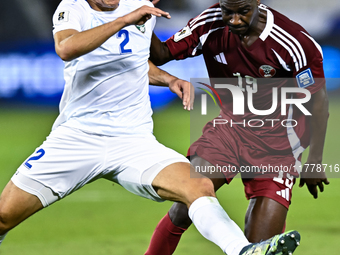 Almoez Ali (#19) of Qatar battles for the ball with Abdukodir Khusanov (#2) of Uzbekistan during the FIFA World Cup 2026 AFC Asian Qualifier...