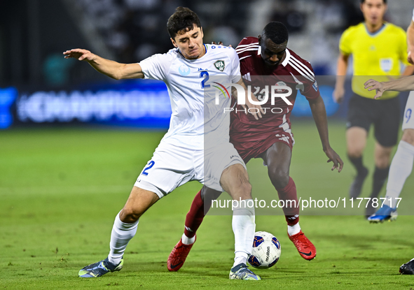 Almoez Ali (#19) of Qatar battles for the ball with Abdukodir Khusanov (#2) of Uzbekistan during the FIFA World Cup 2026 AFC Asian Qualifier...