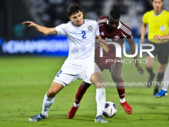 Almoez Ali (#19) of Qatar battles for the ball with Abdukodir Khusanov (#2) of Uzbekistan during the FIFA World Cup 2026 AFC Asian Qualifier...