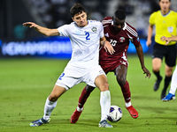 Almoez Ali (#19) of Qatar battles for the ball with Abdukodir Khusanov (#2) of Uzbekistan during the FIFA World Cup 2026 AFC Asian Qualifier...