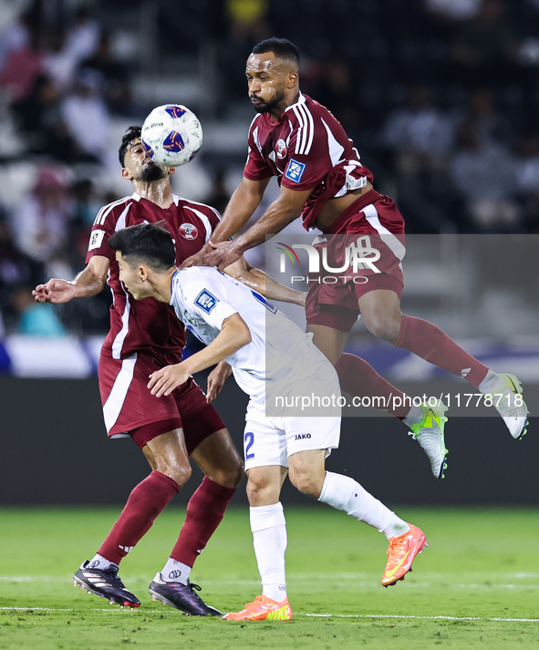 Ahmed Fathy (#20) of Qatar battles for the ball with Abbosbek Fayazullaev (#22) of Uzbekistan during the FIFA World Cup 2026 AFC Asian Quali...